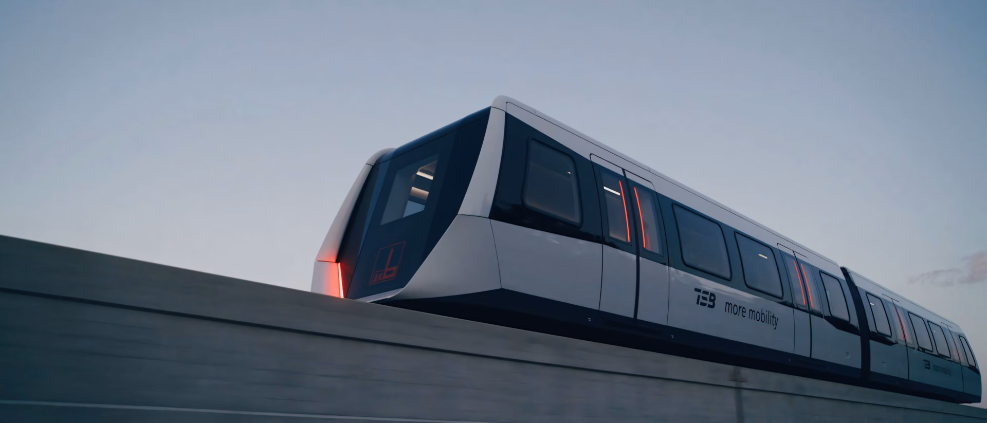A TSB maglev train travels along an elevated guideway at dusk, the guideway blurred by the motion.