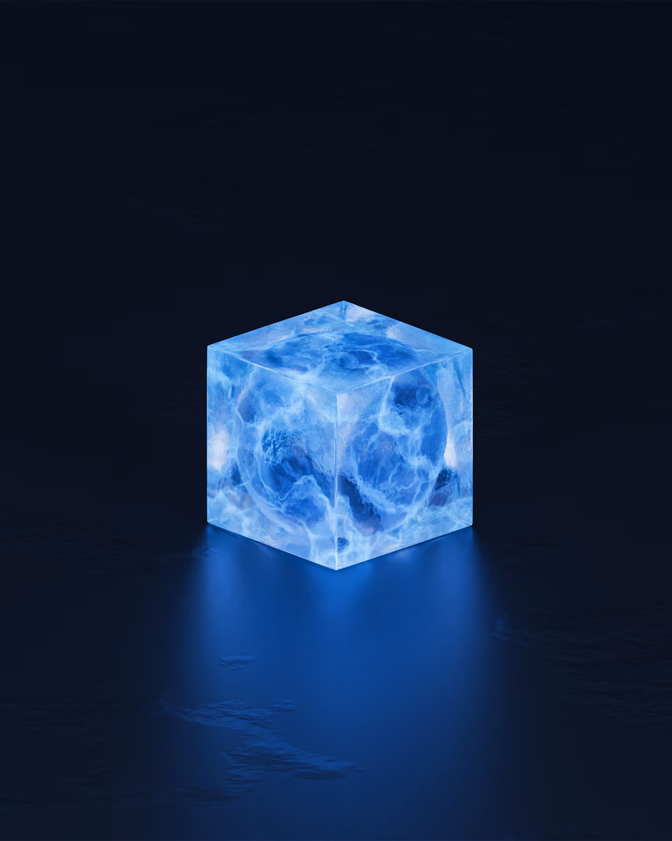 A single translucent blue cube glows on a dark reflective surface, its light spilling onto the floor in front of it.